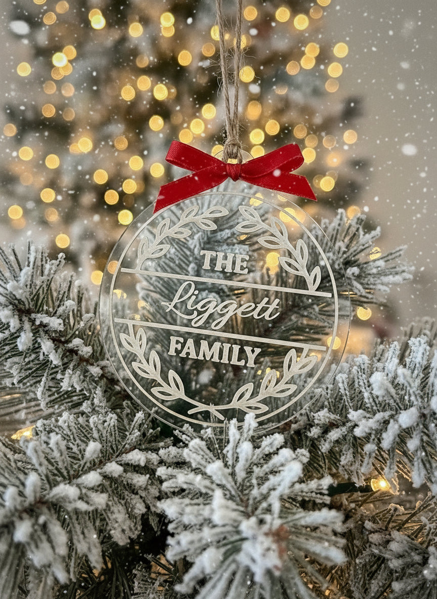 Decorative ornament with 'The Liggett Family' text on a Christmas tree.